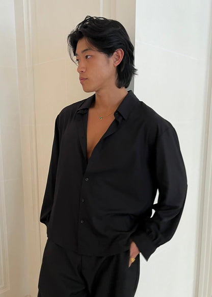 Black poet shirt worn with top buttons undone
