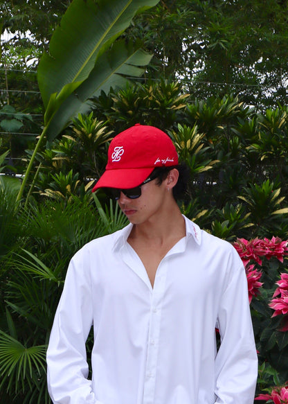 Red cap side view showing handwritten signature embroidery