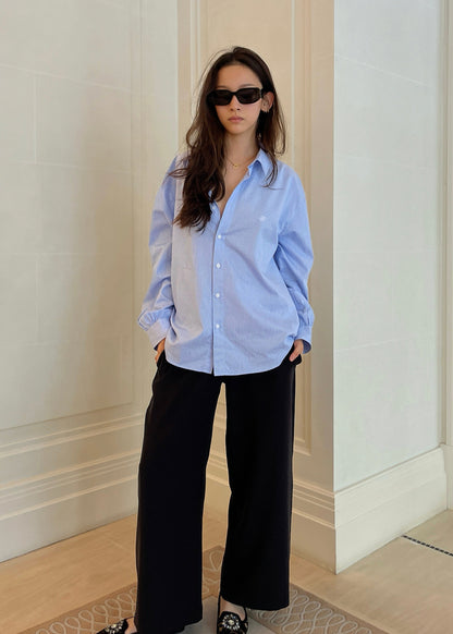 Blue stripe shirt worn open with poet sleeves